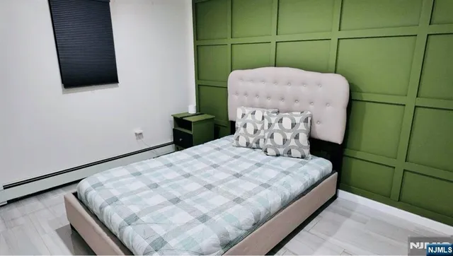 a bedroom with a bed and flat screen tv