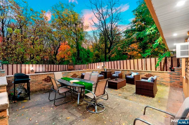 a view of backyard with a table and chairs