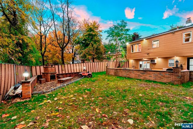 a view of a house with backyard and sitting area