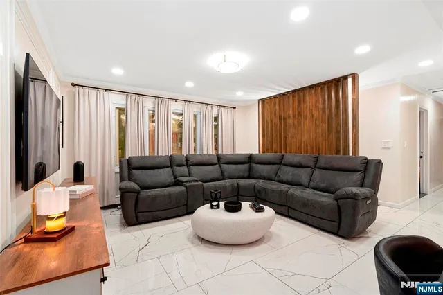 a living room with furniture and a large window