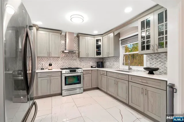 a kitchen with a sink cabinets and stainless steel appliances