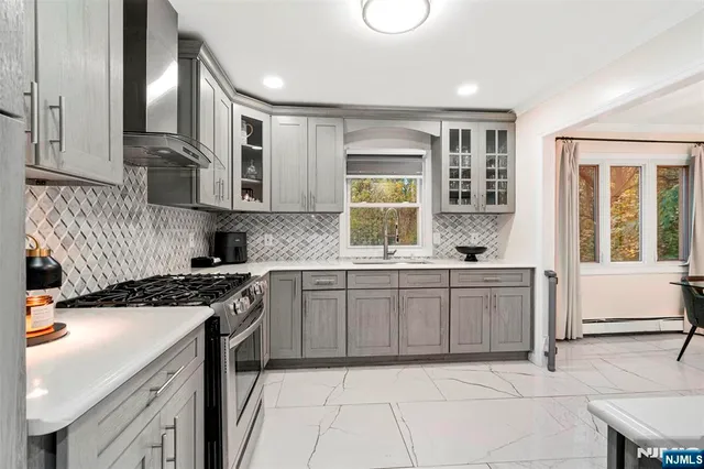a kitchen with a sink stove and cabinets