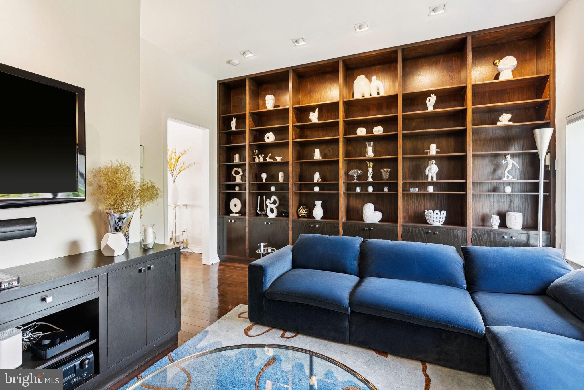3251 Prospect Street Northwest, Unit 402 Washington, DC 20007 - Photo 11 of 36 a living room with furniture a flat screen tv and floor to ceiling window