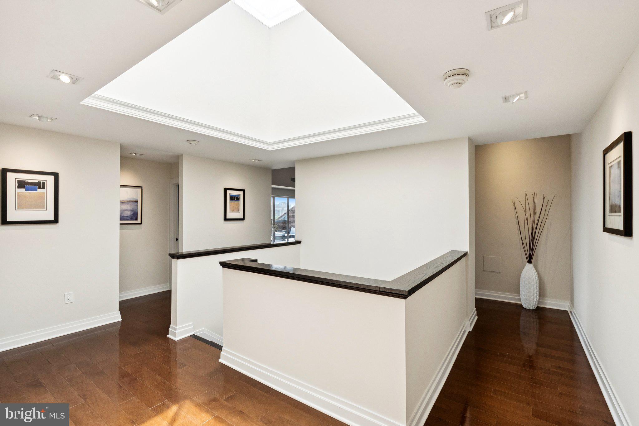 3251 Prospect Street Northwest, Unit 402 Washington, DC 20007 - Photo 13 of 36 a hallway with white cabinets and wooden floor