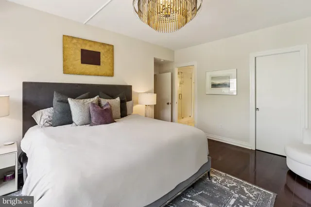 a bedroom with a bed and a painting on the wall