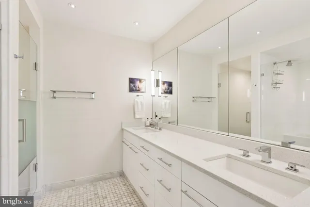 a bathroom with a sink a mirror and a shower