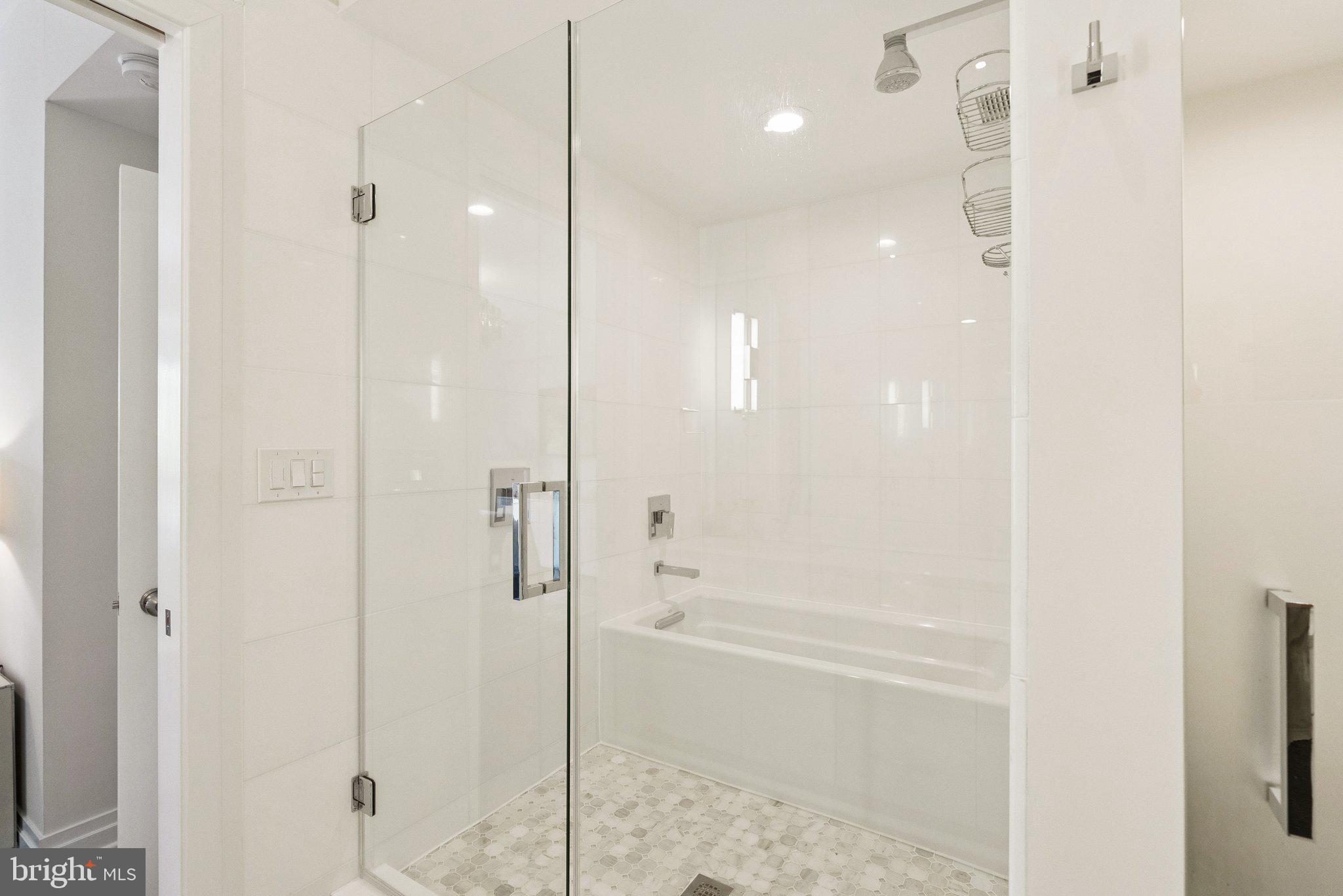 3251 Prospect Street Northwest, Unit 402 Washington, DC 20007 - Photo 18 of 36 a bathroom with a shower and a glass door