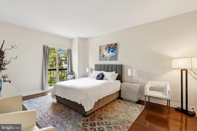 a bedroom with a bed and a large window