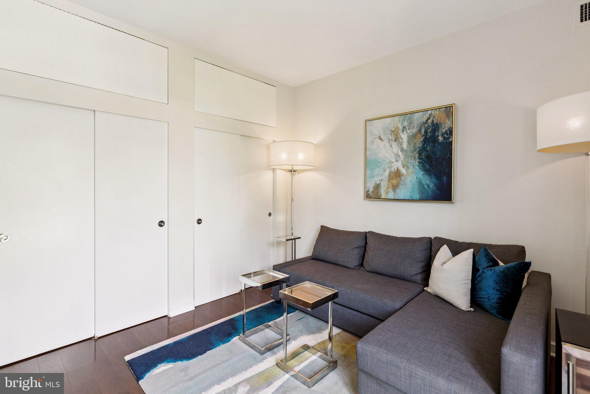 3251 Prospect Street Northwest, Unit 402 Washington, DC 20007 - Photo 24 of 36 a living room with furniture and a wooden floor