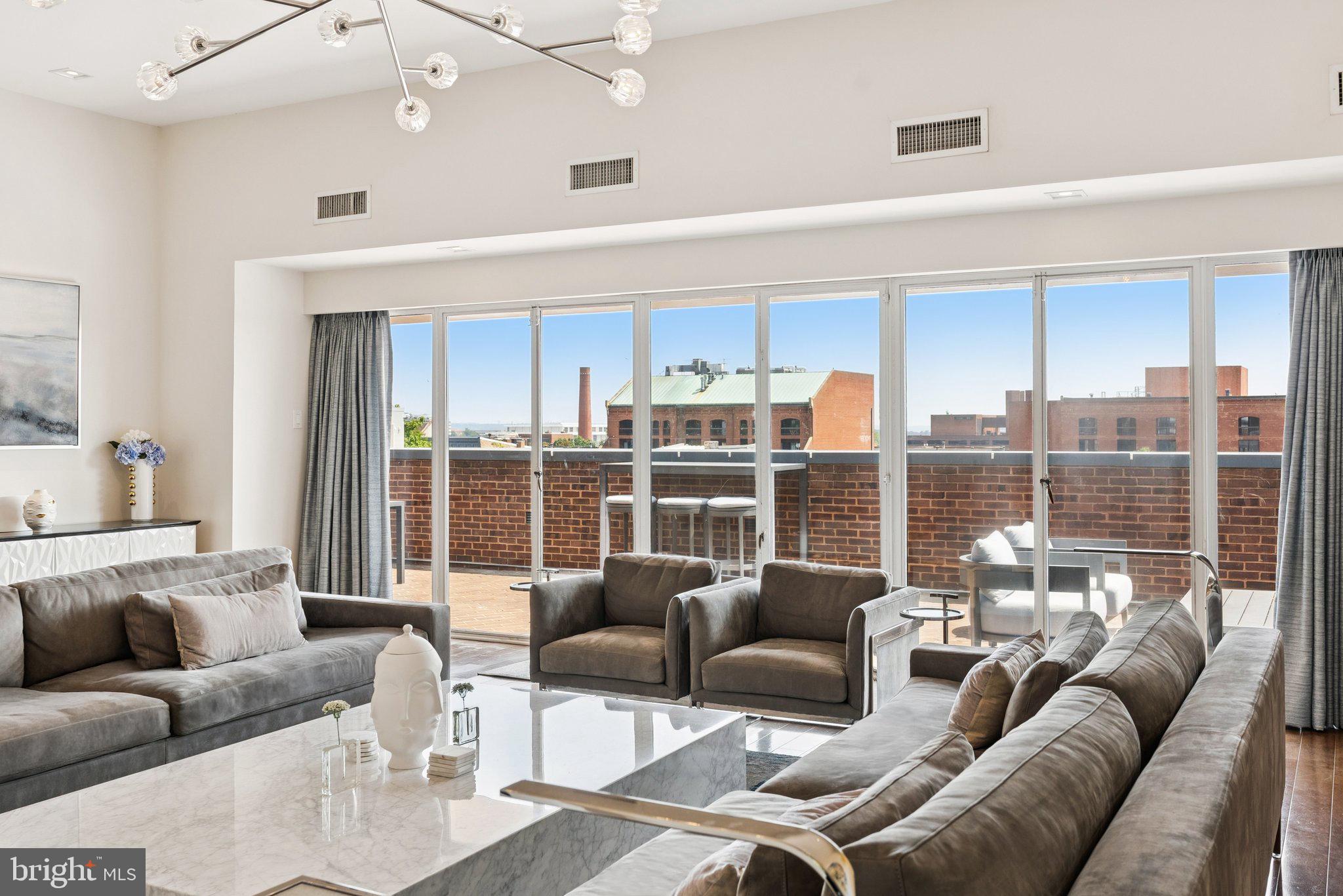3251 Prospect Street Northwest, Unit 402 Washington, DC 20007 - Photo 25 of 36 a living room with furniture and a large window