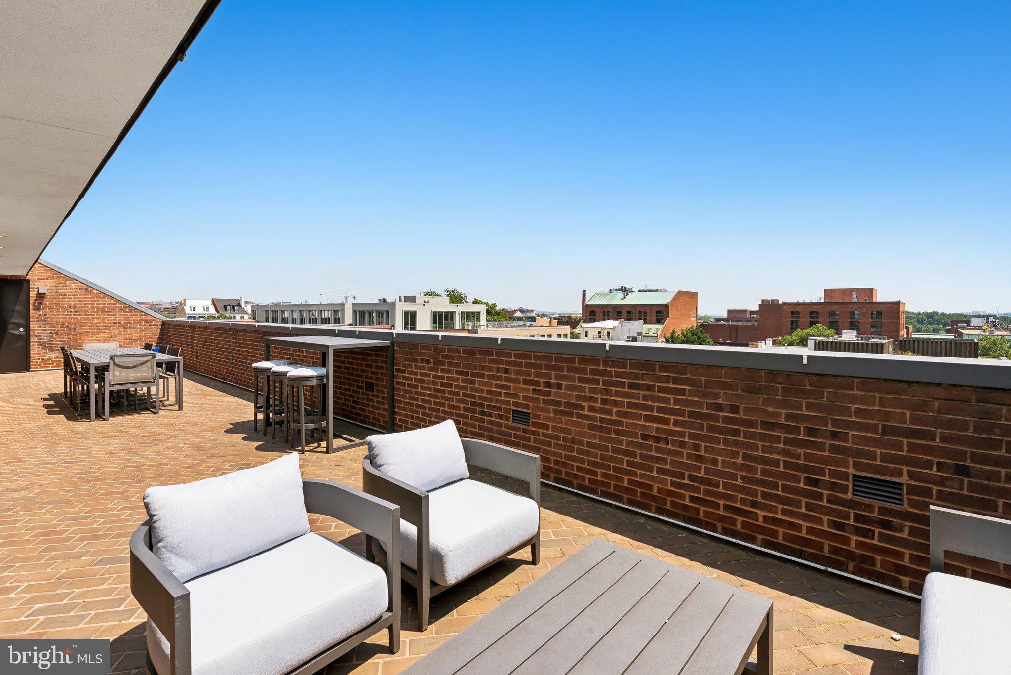 3251 Prospect Street Northwest, Unit 402 Washington, DC 20007 - Photo 27 of 36 a view of roof deck with seating space and a barbeque