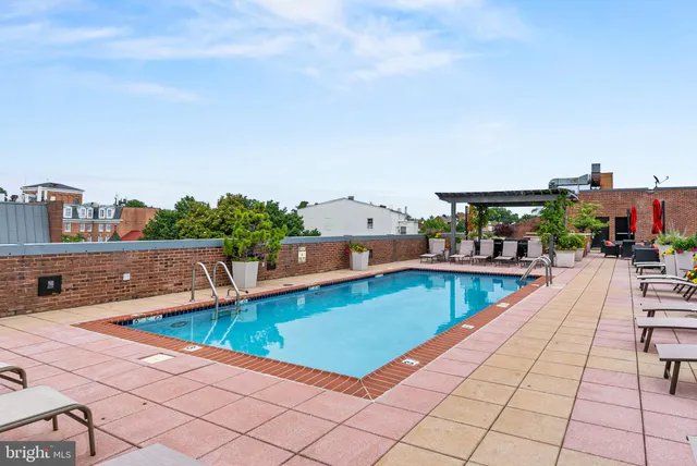 swimming pool view with a seating space