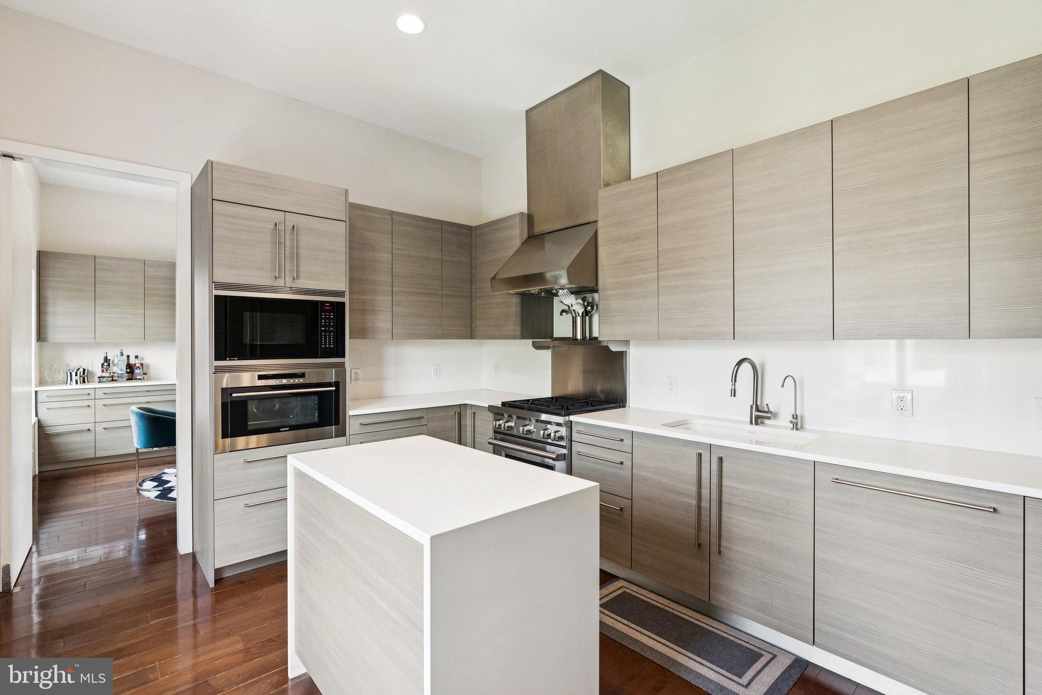 3251 Prospect Street Northwest, Unit 402 Washington, DC 20007 - Photo 10 of 36 a kitchen with a sink a stove and cabinets