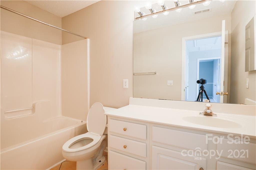 10328 Flat Stone Road Charlotte, NC 28213 - Photo 13 of 14 a bathroom with a sink toilet and shower
