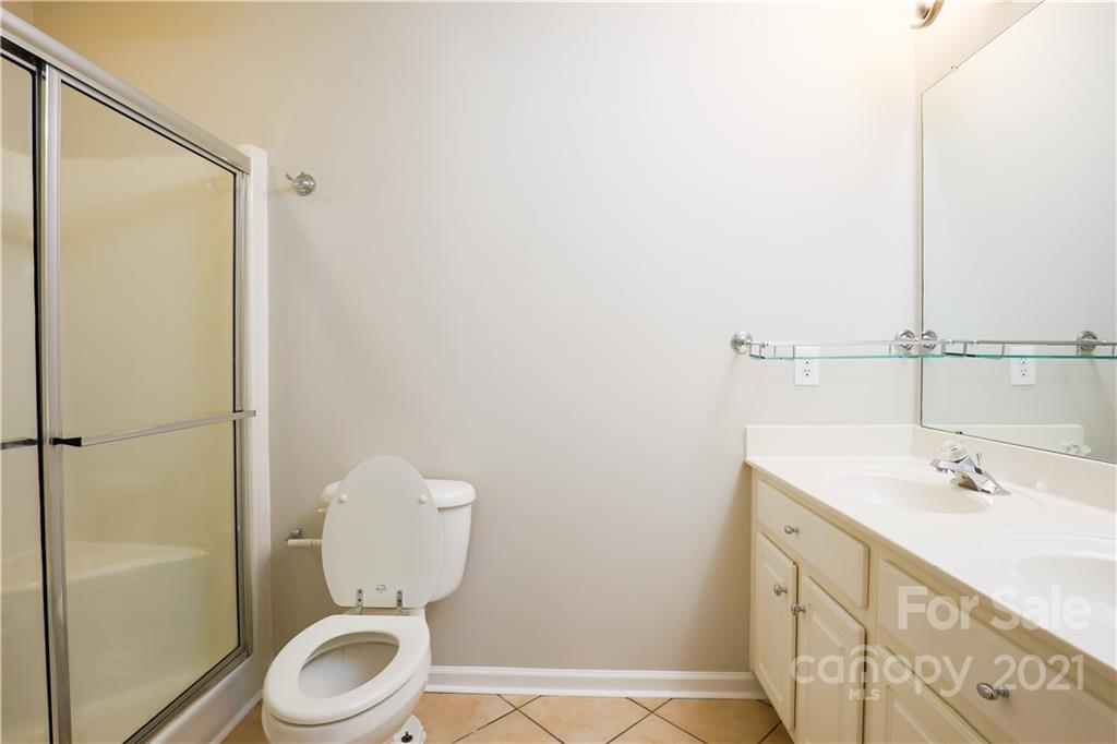10328 Flat Stone Road Charlotte, NC 28213 - Photo 8 of 14 a bathroom with a sink a toilet and shower