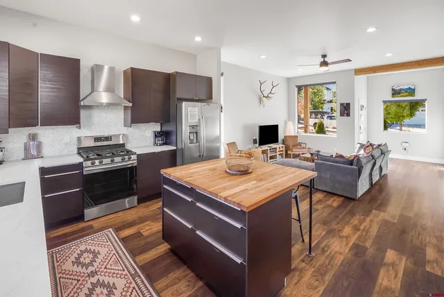 a kitchen with a stove a refrigerator and a stove top oven