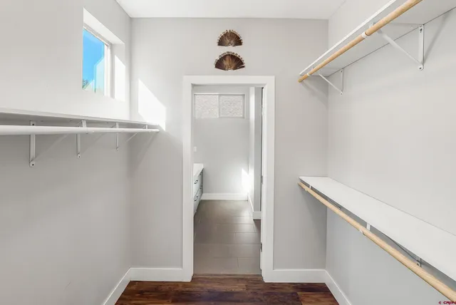 a bathroom with a double vanity sink a mirror and a shower