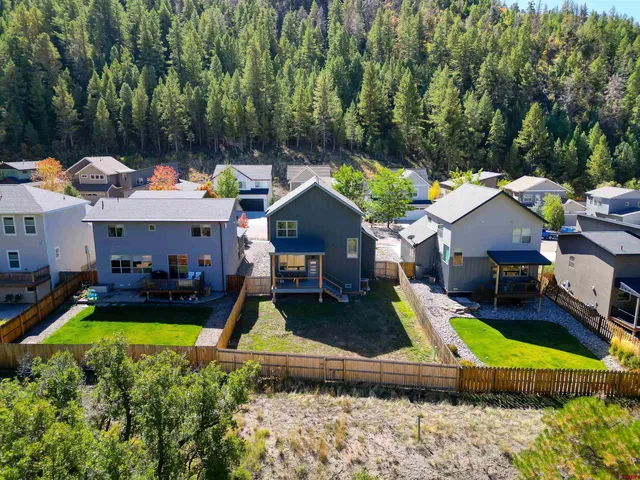 a view of a house with pool and chairs