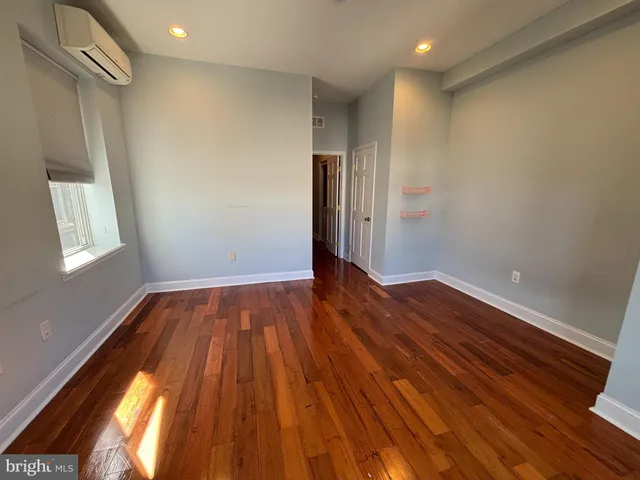 a view of room with window and wooden floor