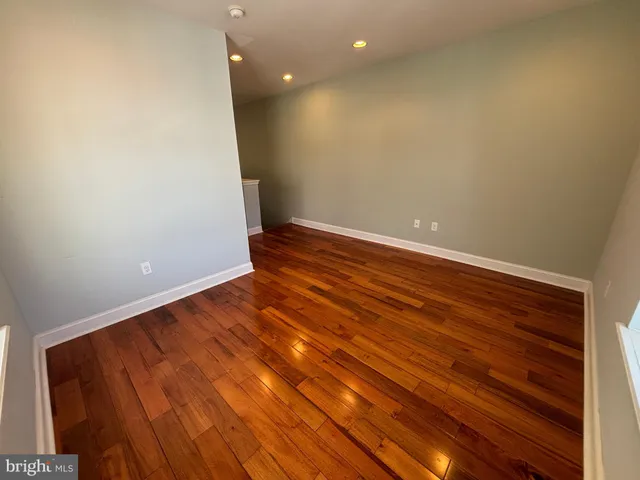 a view of room with wooden floor and fan