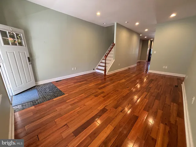 a view of a room with wooden floor and stairs