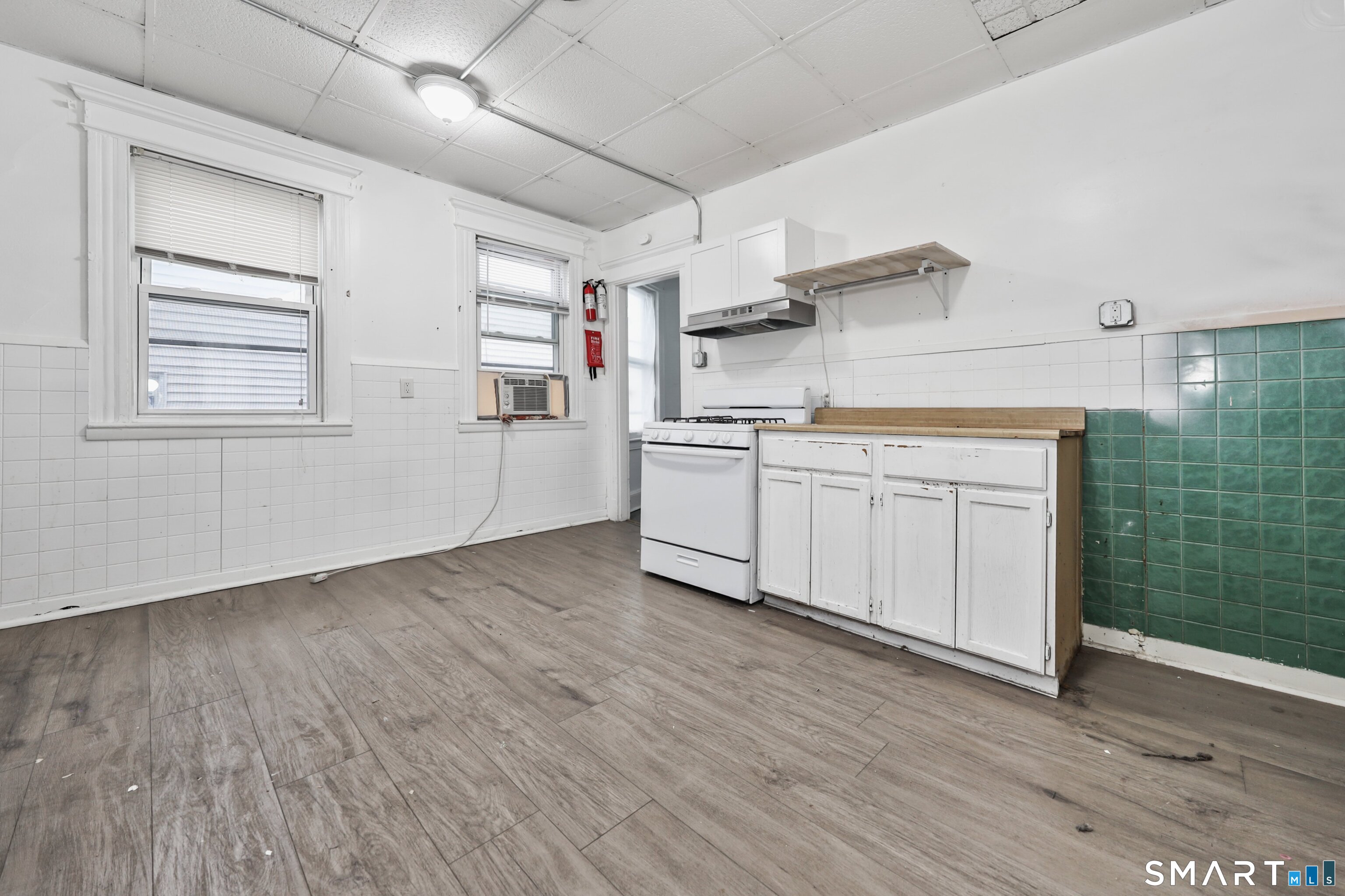 82 Bunker Hill Avenue Waterbury, CT 06708 - Photo 15 of 37 a kitchen with stainless steel appliances granite countertop a sink and wooden floors