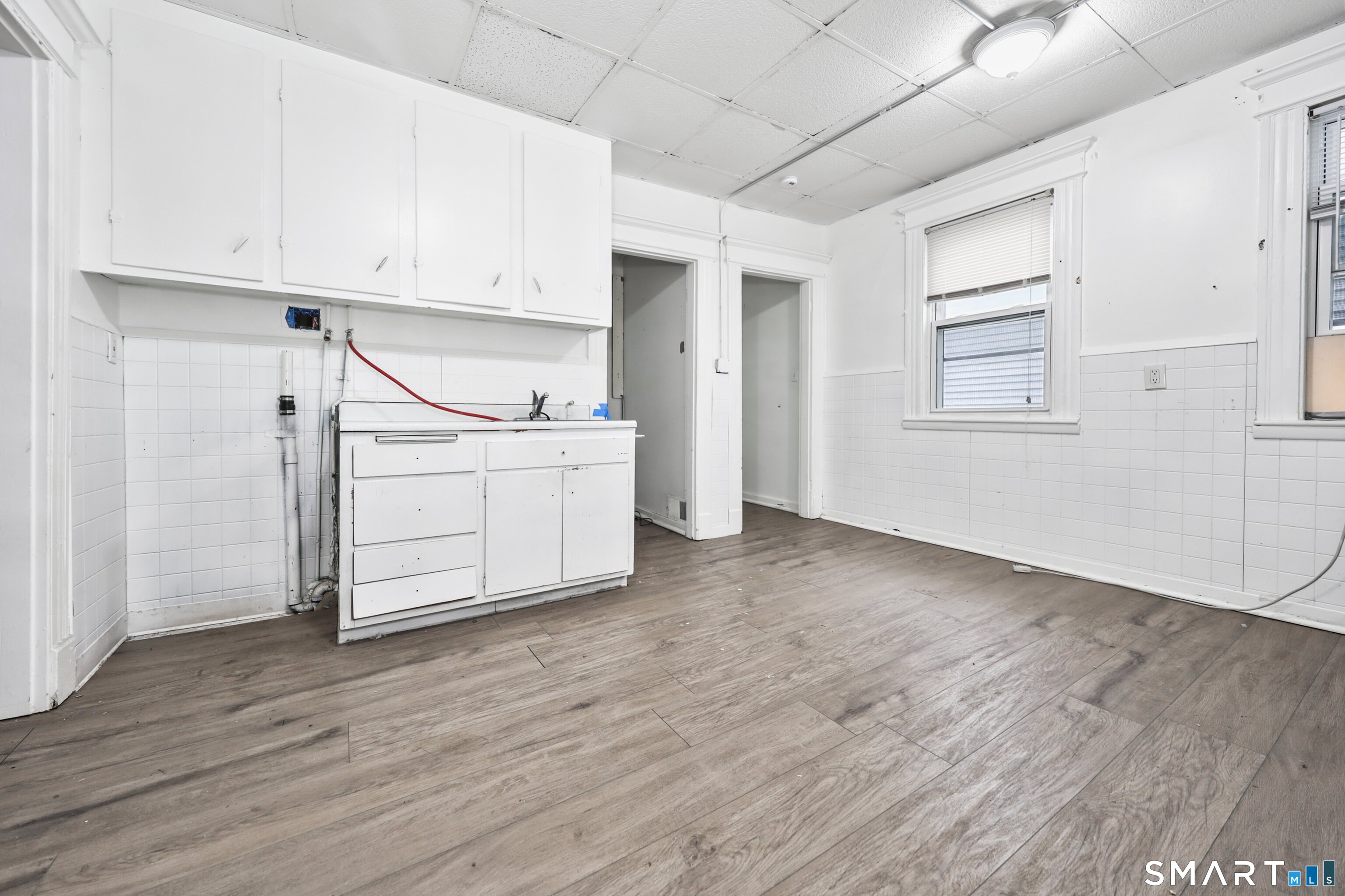 82 Bunker Hill Avenue Waterbury, CT 06708 - Photo 16 of 37 an empty room with wooden floor and windows