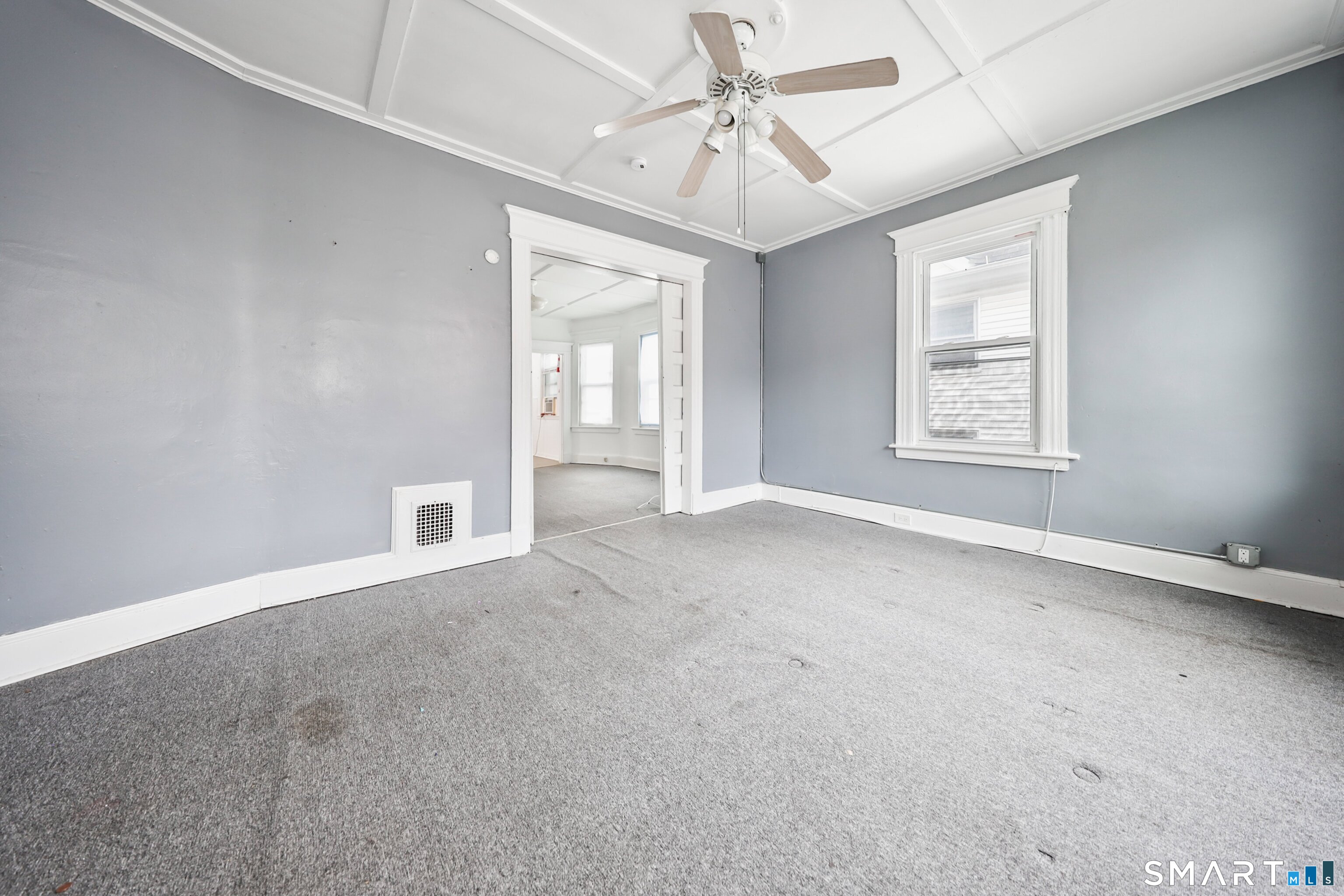 82 Bunker Hill Avenue Waterbury, CT 06708 - Photo 26 of 37 an empty room with chandelier fan and windows