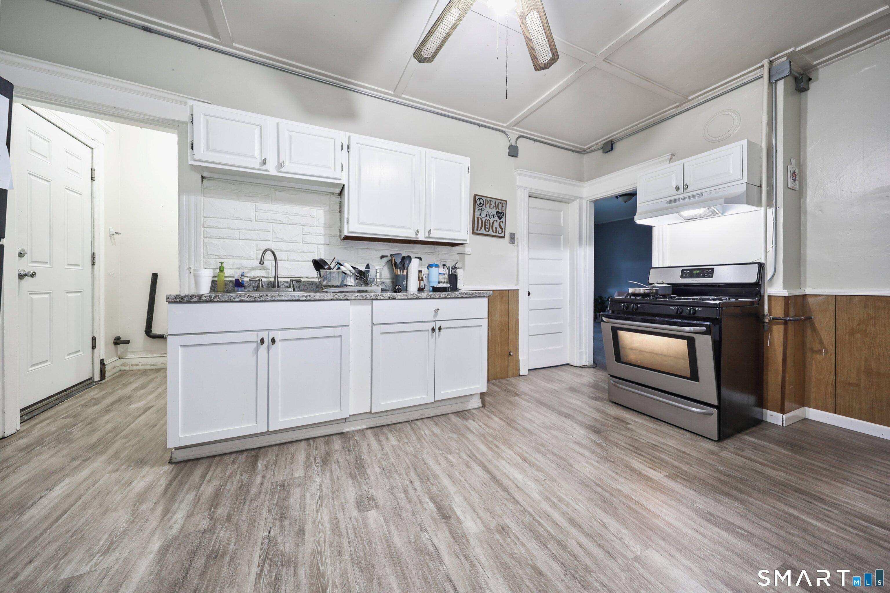 82 Bunker Hill Avenue Waterbury, CT 06708 - Photo 28 of 37 a kitchen with a sink dishwasher and wooden cabinets