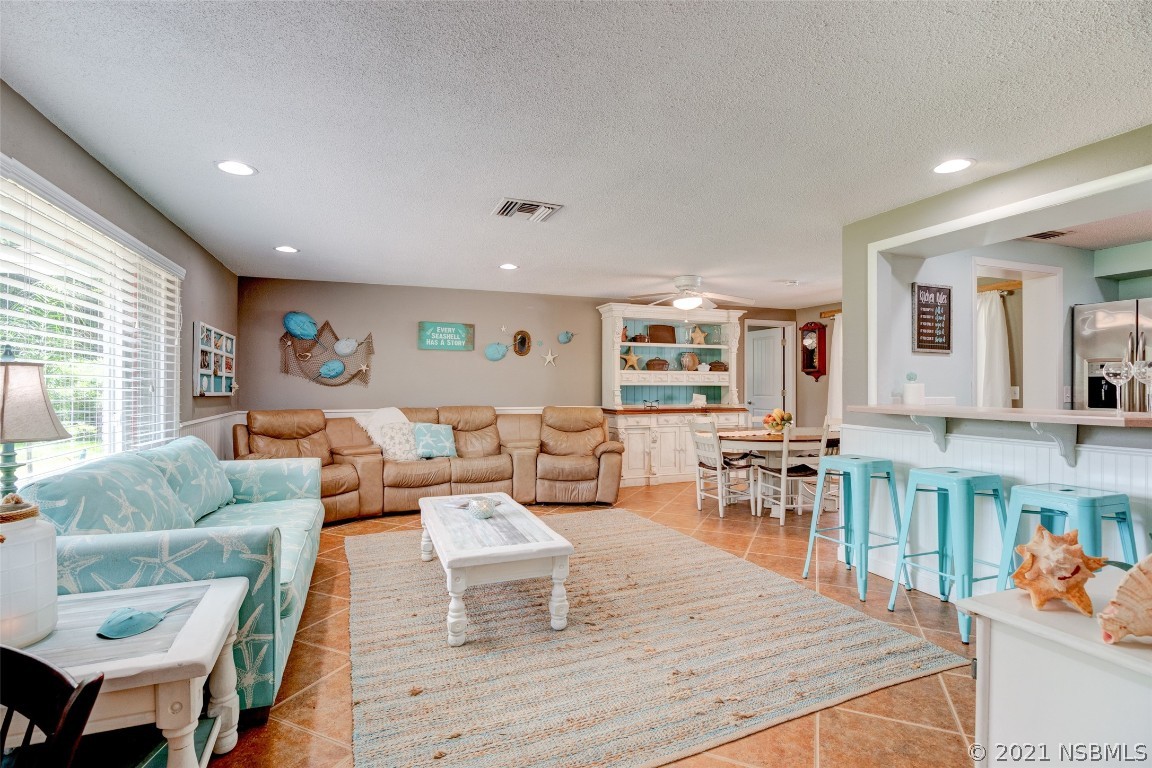 134 Arbor Lane Edgewater, FL 32141 - Photo 13 of 36 a living room with furniture wooden floor and a large window