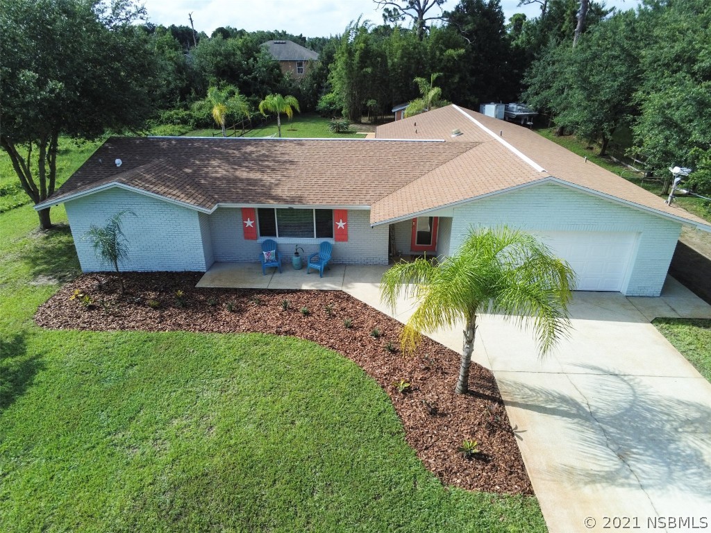 134 Arbor Lane Edgewater, FL 32141 - Photo 2 of 36 a view of a house with a yard and potted plants