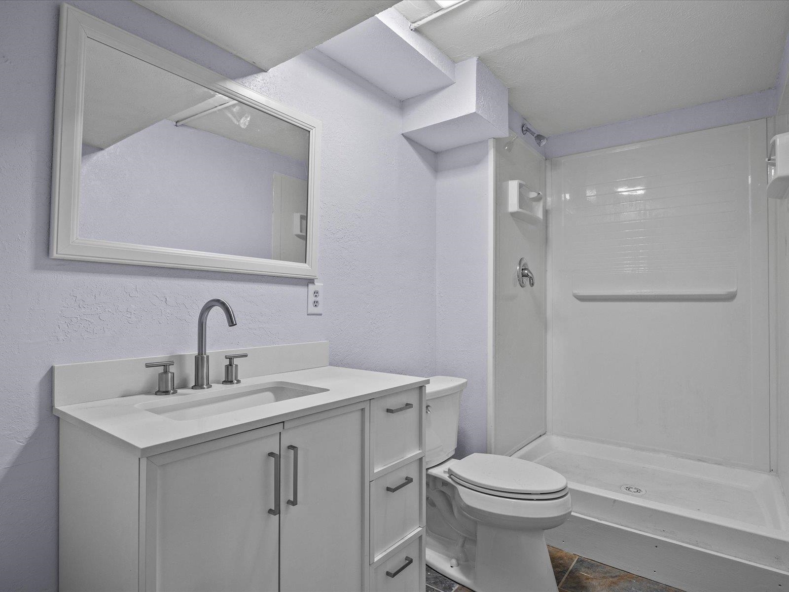 246 East Rangely Avenue Rangely, CO 81648 - Photo 17 of 21 a bathroom with a sink toilet vanity and shower