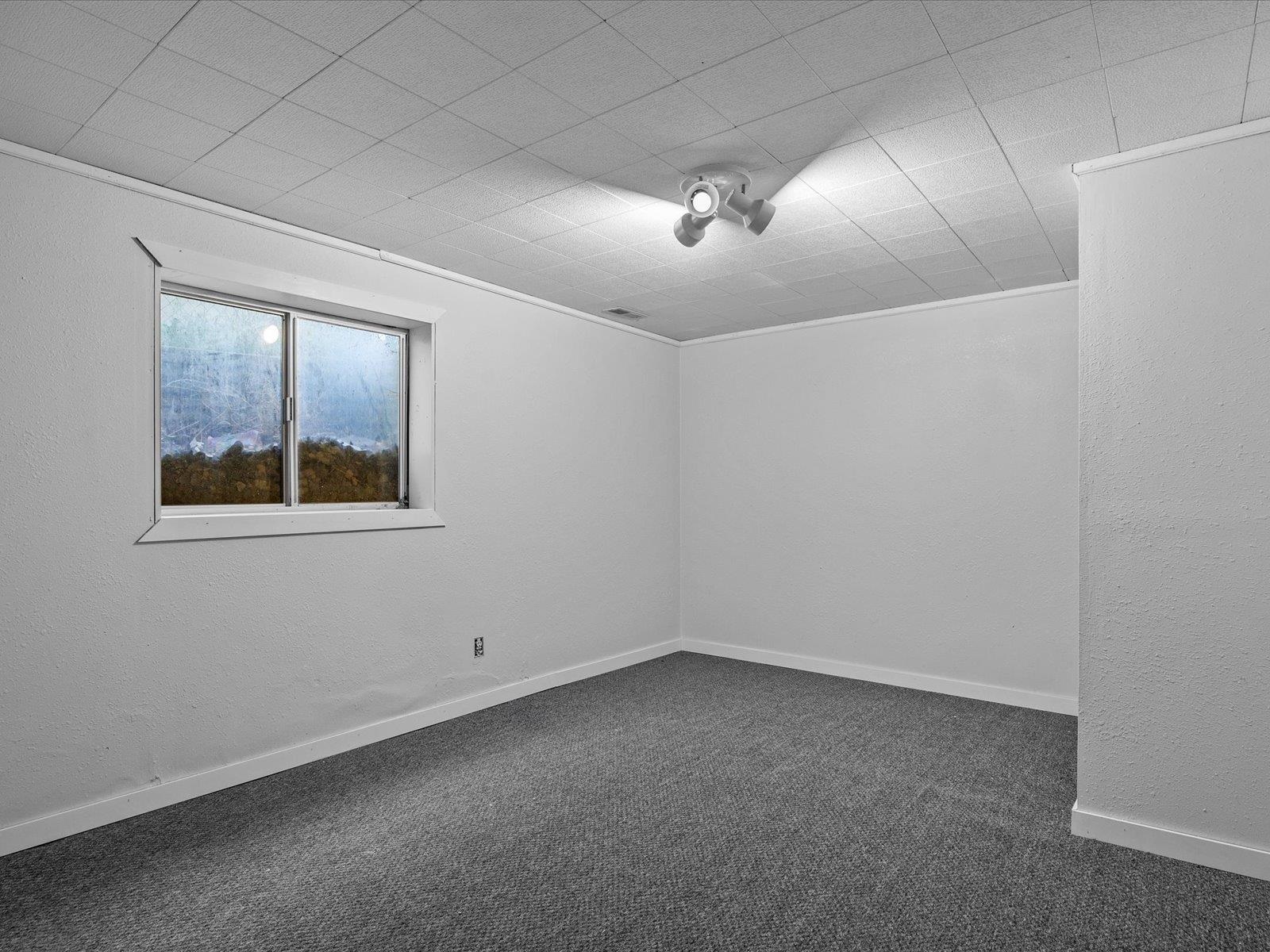 246 East Rangely Avenue Rangely, CO 81648 - Photo 18 of 21 an empty room with windows and fan