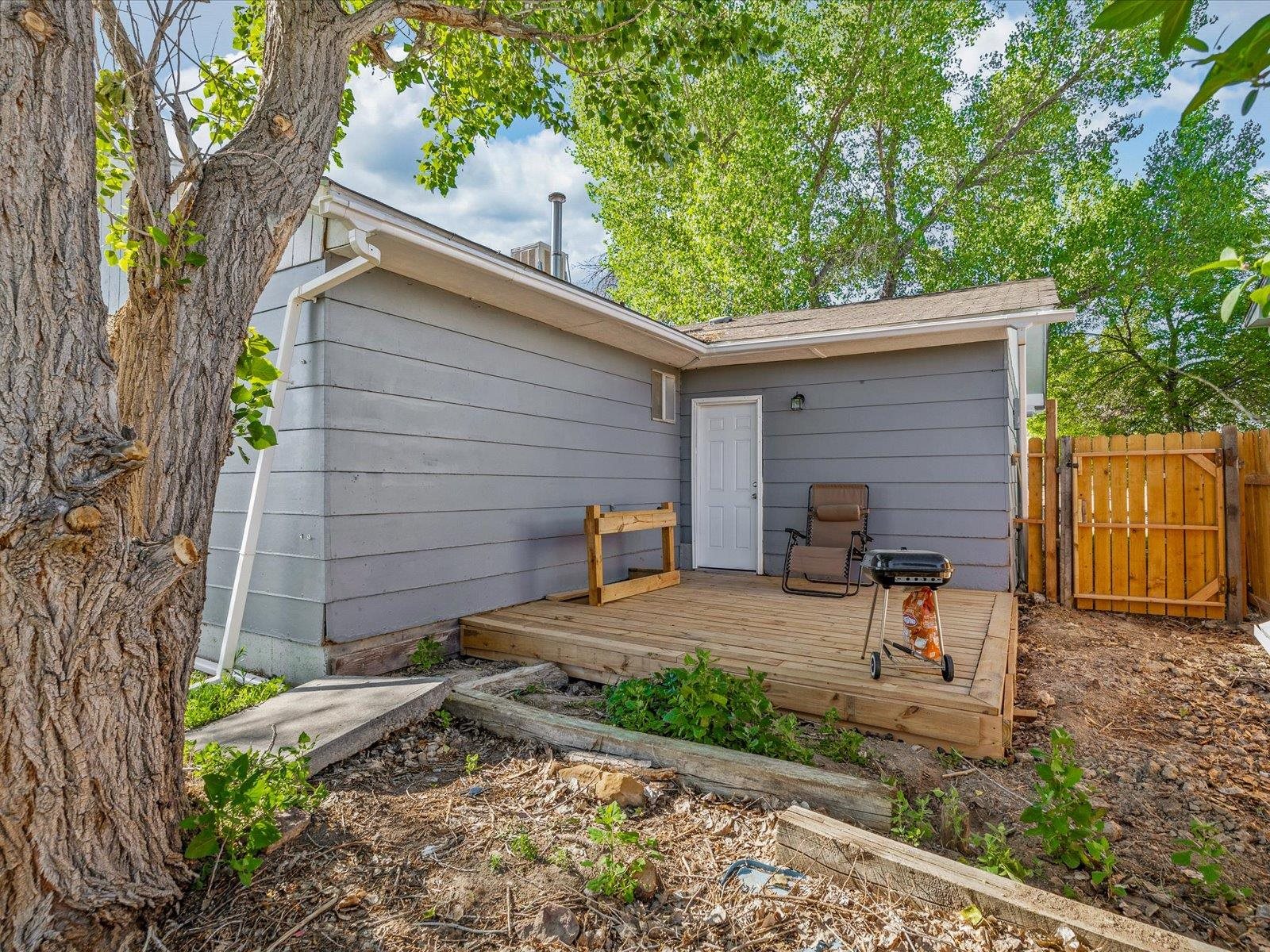 246 East Rangely Avenue Rangely, CO 81648 - Photo 21 of 21 a view of a backyard with plants and a tree