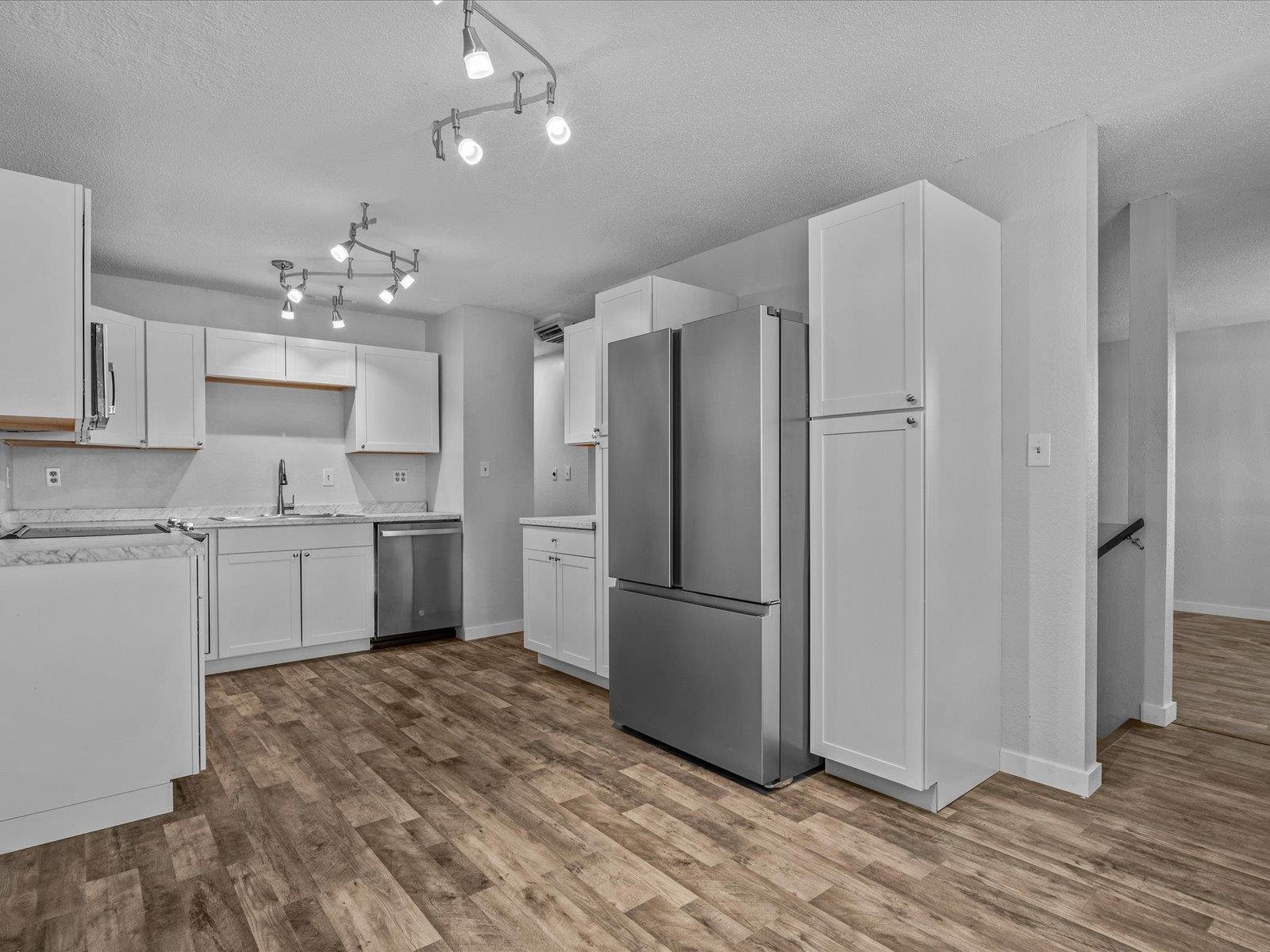 246 East Rangely Avenue Rangely, CO 81648 - Photo 5 of 21 a kitchen with granite countertop a refrigerator and a sink