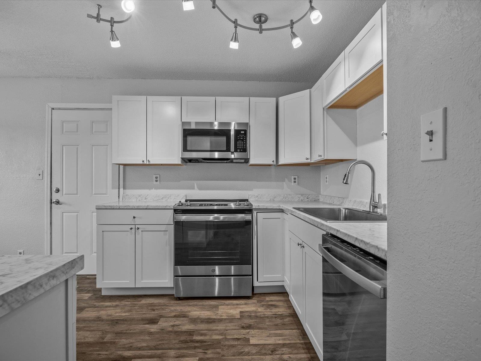 246 East Rangely Avenue Rangely, CO 81648 - Photo 6 of 21 a kitchen with kitchen island granite countertop a stove sink and cabinets