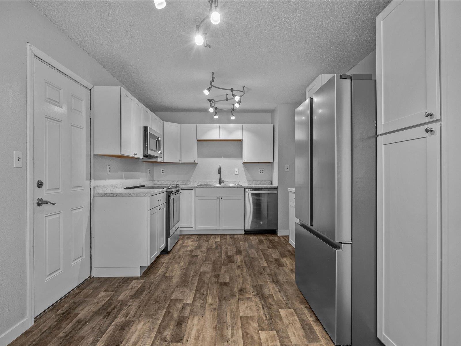 246 East Rangely Avenue Rangely, CO 81648 - Photo 7 of 21 a kitchen with stainless steel appliances a refrigerator sink and cabinets