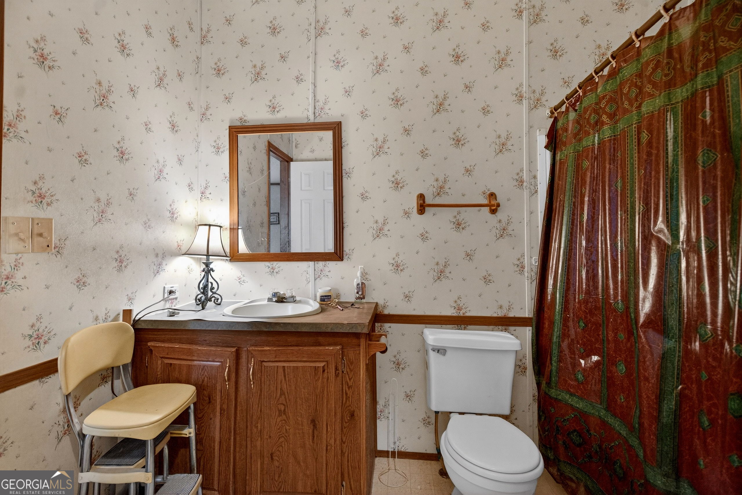 345 Robert Taylor Road LaGrange, GA 30240 - Photo 12 of 15 a bathroom with a toilet a sink and mirror