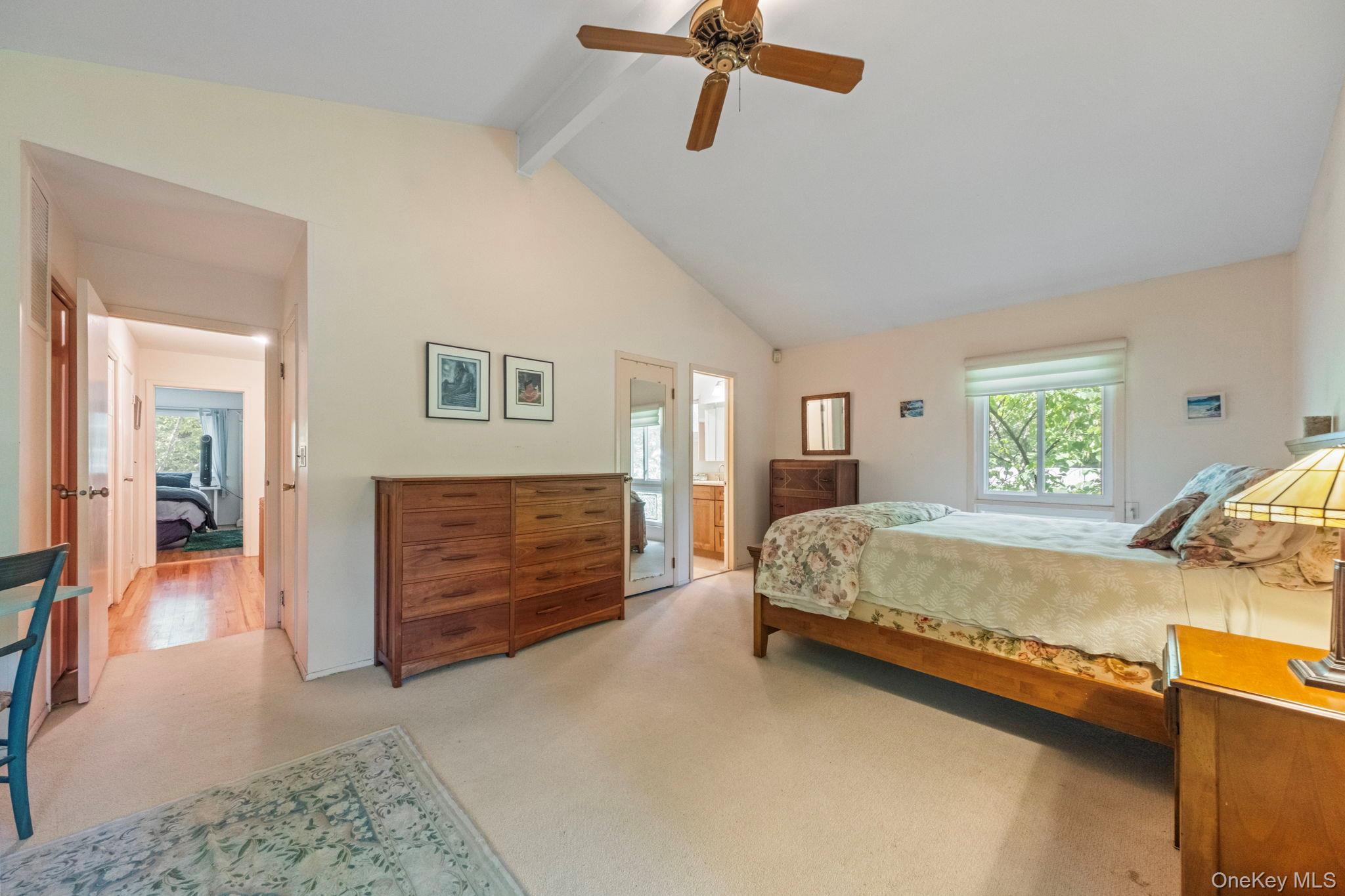 73 Bramblebrook Road Ardsley, NY 10502 - Photo 21 of 35 Carpeted bedroom with a vaulted ceiling, wood-finish ceiling fan, and a large window