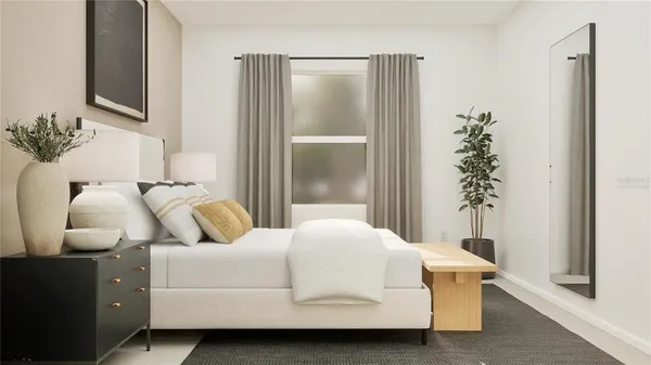 a bedroom with a bed and a potted plant