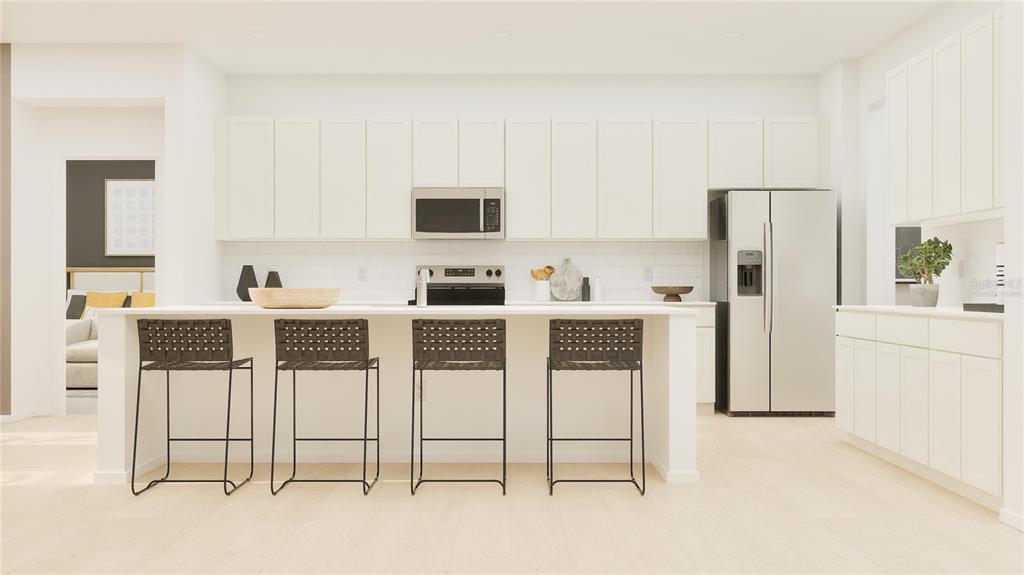 5629 Banyan Bay Road St. Cloud, FL 34771 - Photo 2 of 35 a kitchen with stainless steel appliances kitchen island granite countertop a refrigerator and cabinets