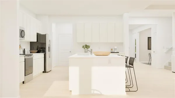 a kitchen with a sink a refrigerator and a stove top oven