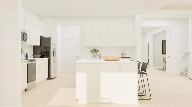 a kitchen with a sink a refrigerator and a stove top oven