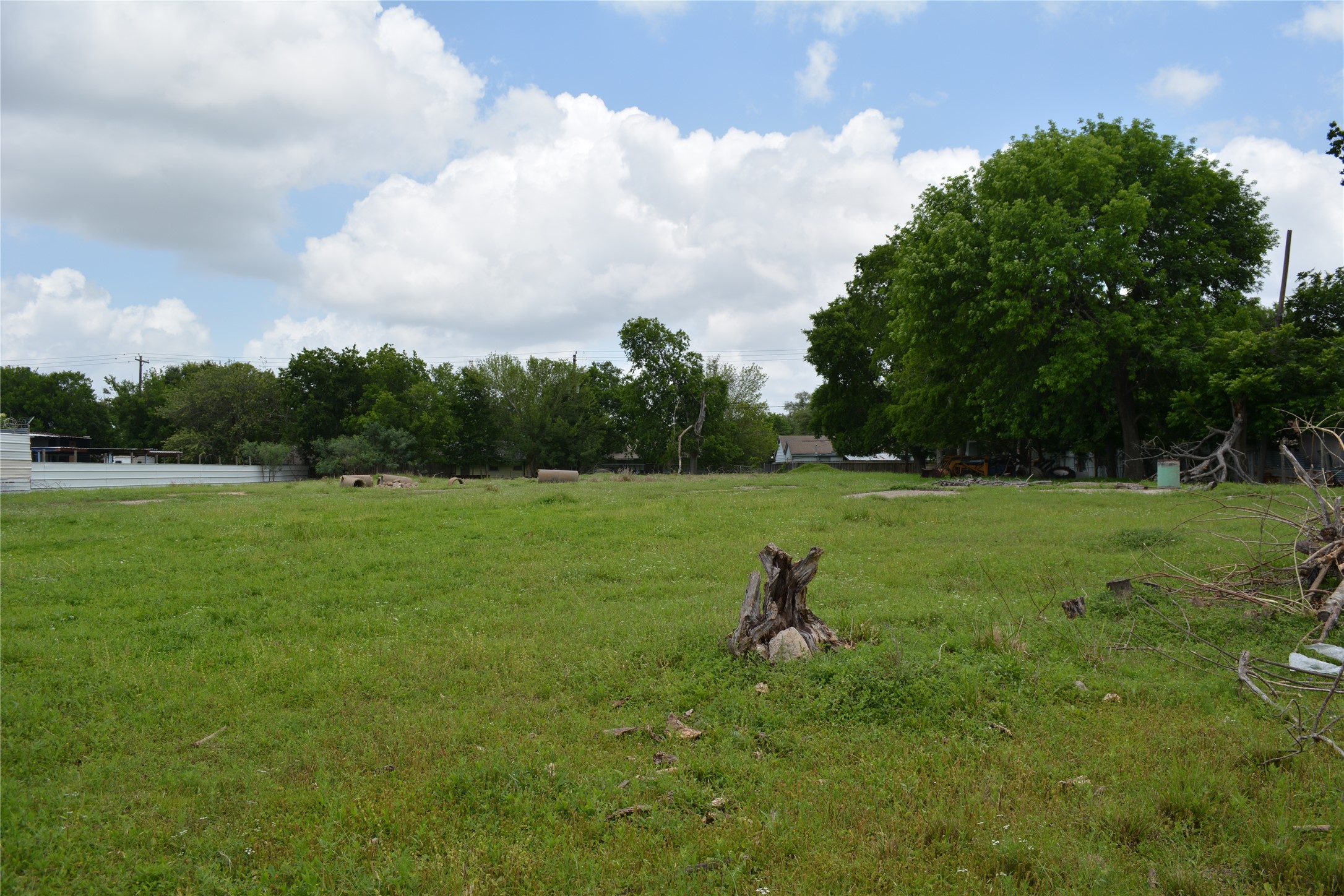 0 Reed Road Houston, TX 77033 - Photo 11 of 24 a view of a green field with wooden fence