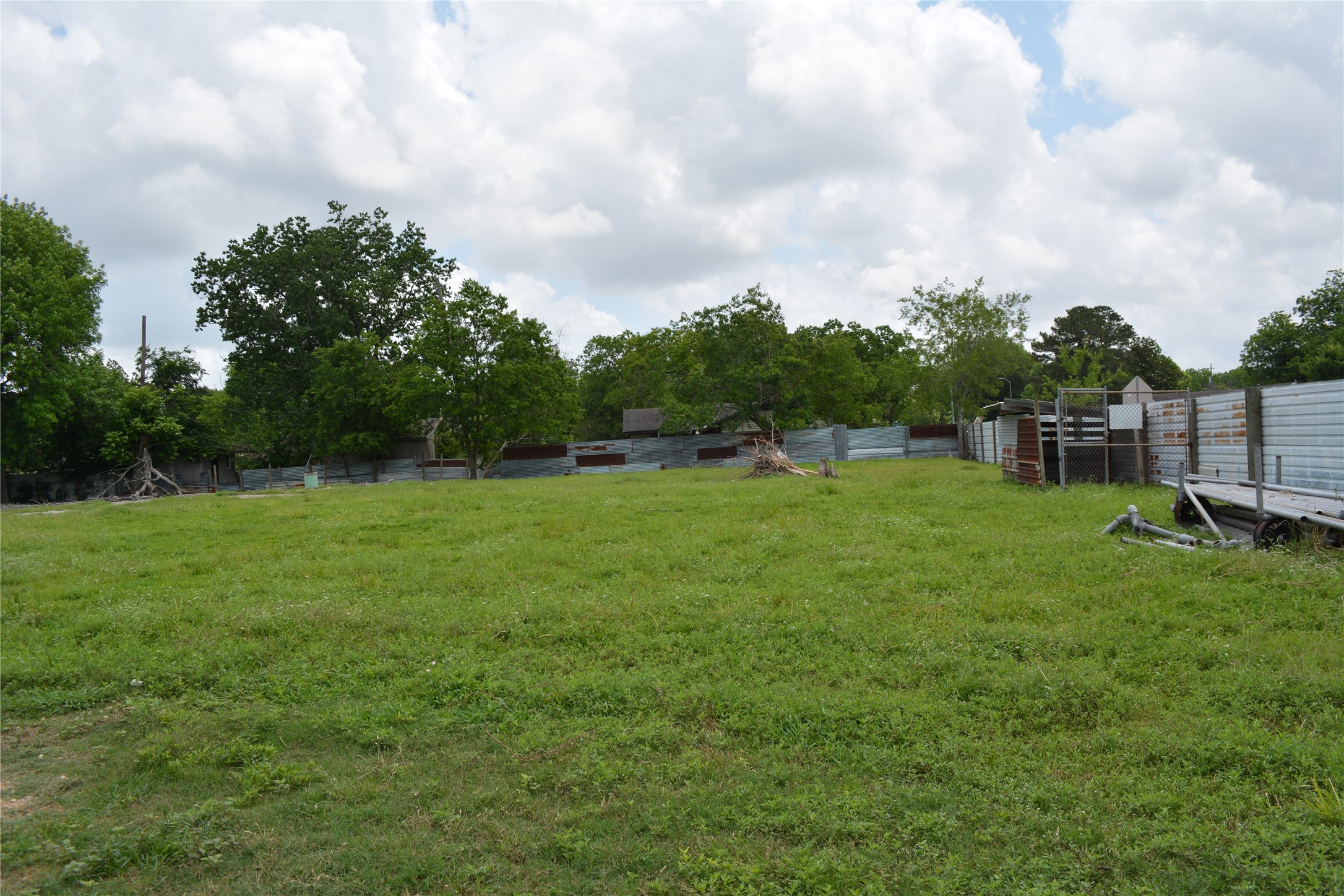 0 Reed Road Houston, TX 77033 - Photo 5 of 24 a view of a green field with wooden fence