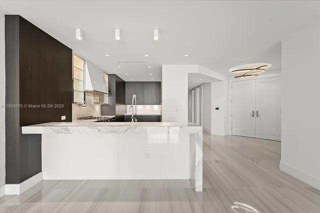 a kitchen with stainless steel appliances granite countertop a stove a refrigerator and a sink