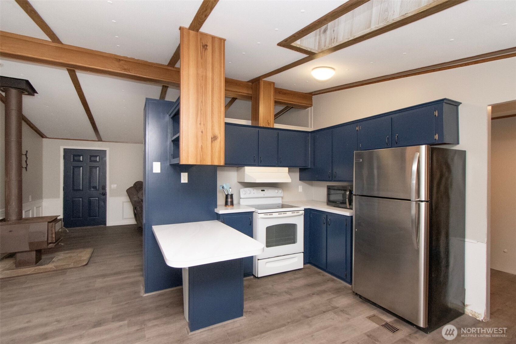491 Mill Road, Unit 30 Sequim, WA 98382 - Photo 12 of 39 a kitchen with refrigerator and wooden cabinets