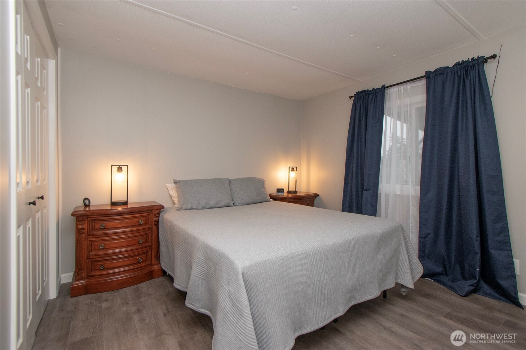 491 Mill Road, Unit 30 Sequim, WA 98382 - Photo 18 of 39 a bedroom with a bed and a night stand