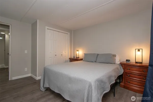 a bedroom with a bed and a lamp