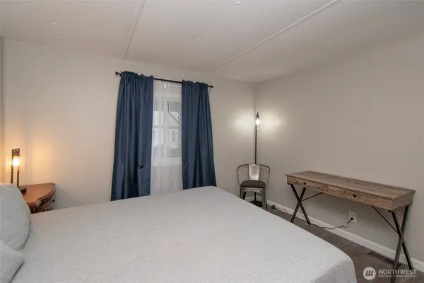 a bedroom with a bed and a lamp